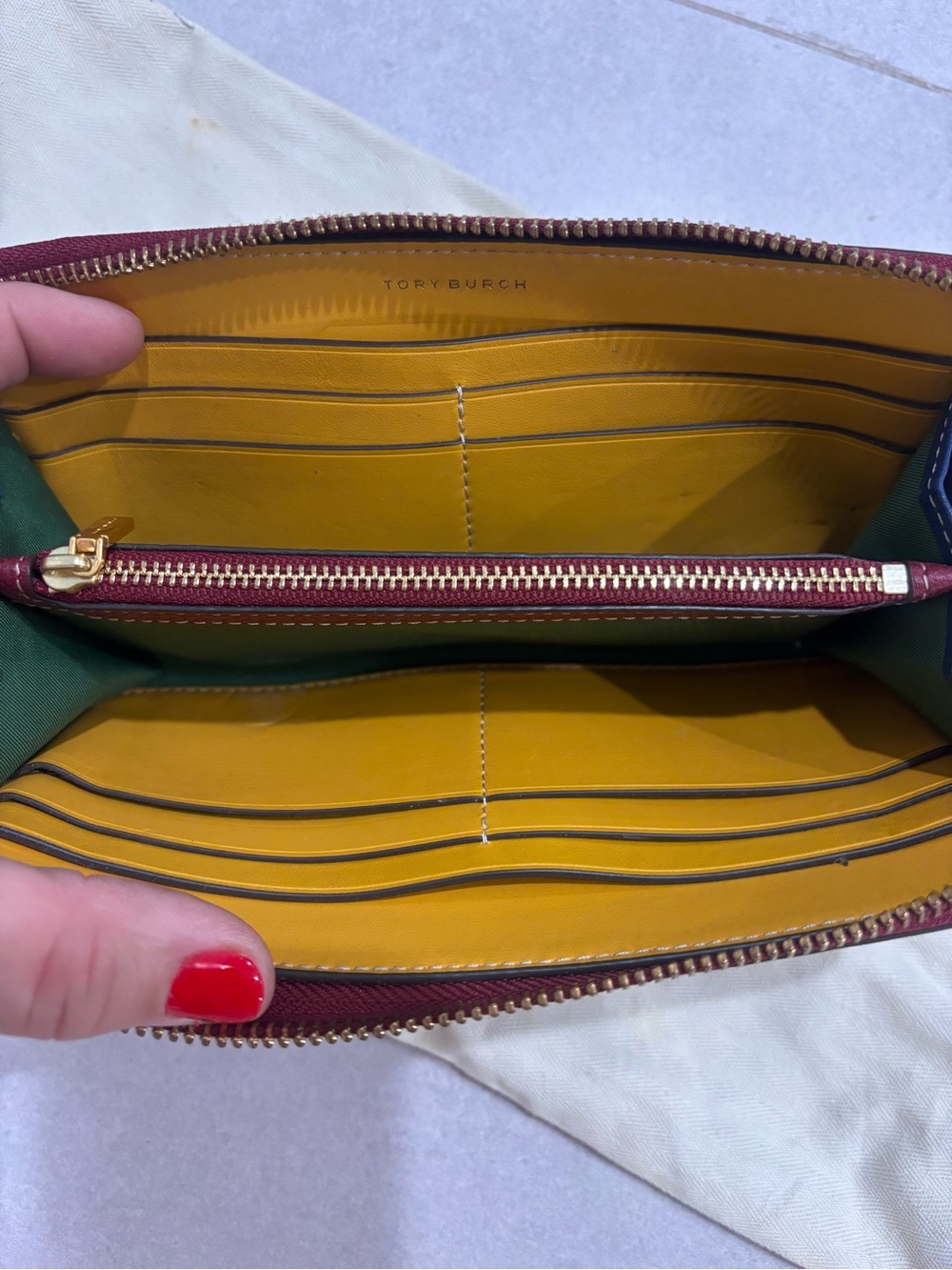 Tory Burch zip-around leather wallet in burgundy with mustard interior